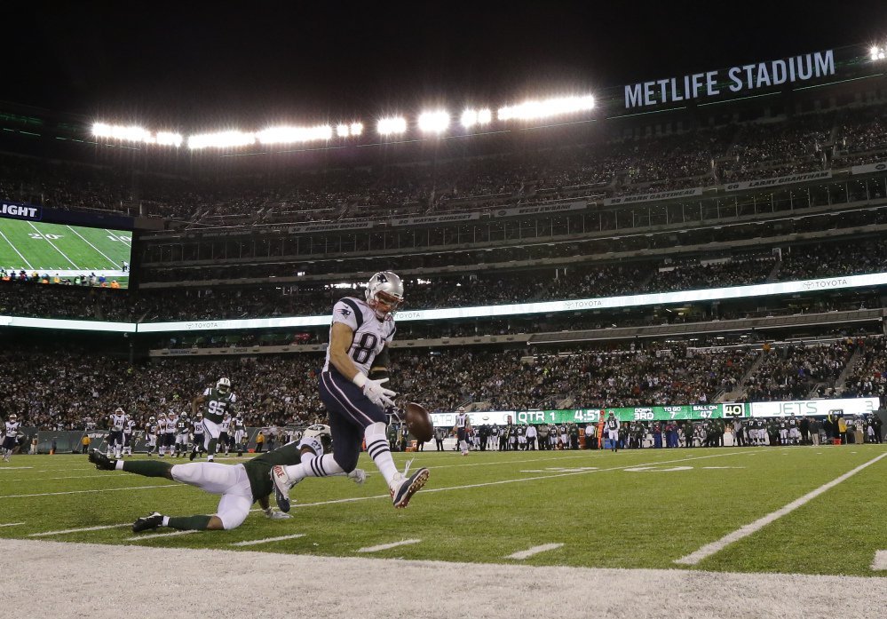 Jets' cornerback Darryl Roberts breaks up a pass intended for Patriots' tight end Rob Gronkowski during the first quarter Sunday in East Rutherford, New Jersey. Gronkowski left the game with a back injury and is questionable to return.