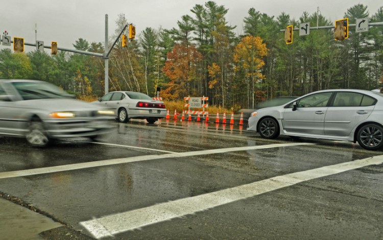 Vehicles drive through the intersection of Civic Center and Darin drives on Thursday in Augusta, where new traffic signals have been mounted but not yet activated.