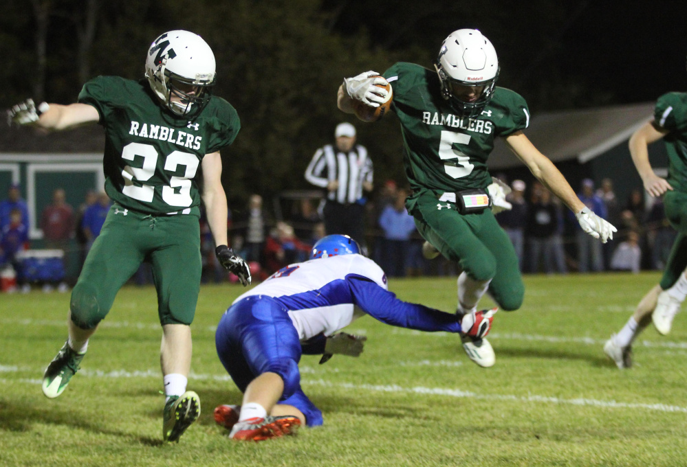 Winthrop/Monmouth running back Nate Scott gets tripped up by Oak Hill defender Austin Noble during a Campbell Conference Class D game last season in Winthrop.