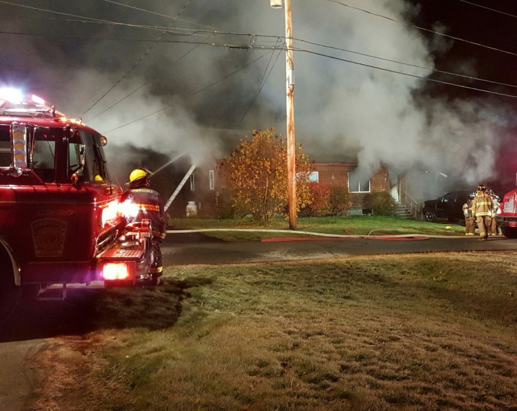 Firefighters work to contain a blaze at 39 Fairview Ave. in Randolph, which was destroyed by fire Saturday morning.