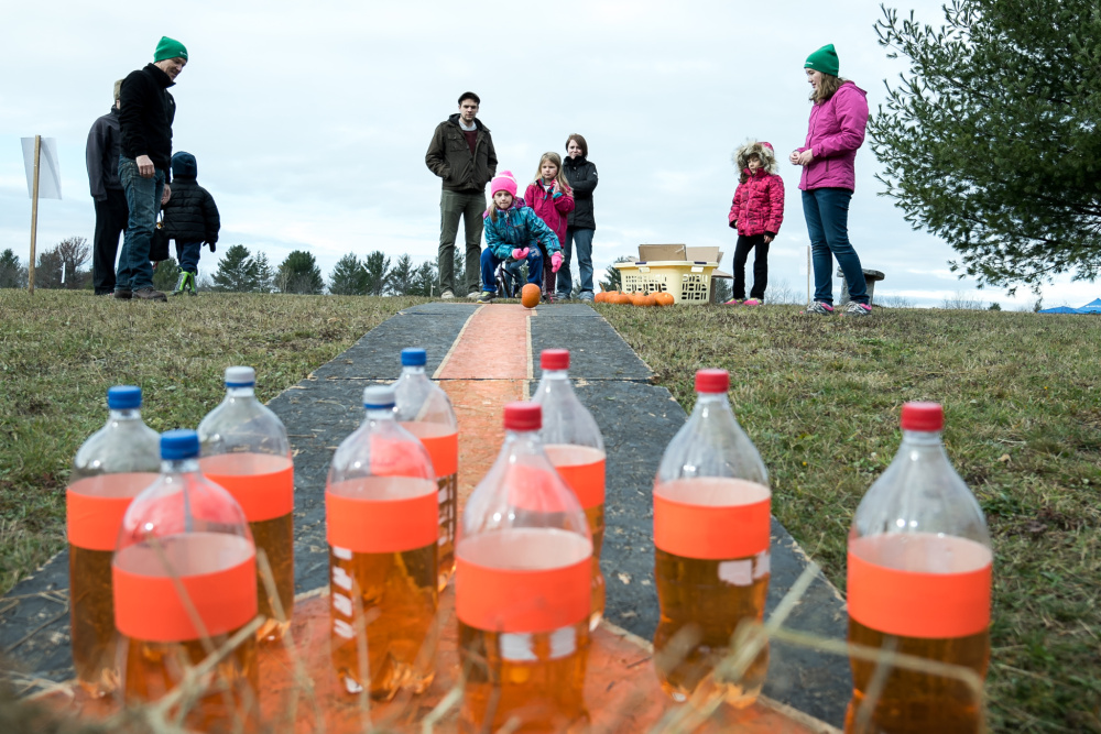 Trying to roll a pumpkin in a straight line capture children's attention Saturday at the pumpkin bowling activity  at the Quarry Road Trails recreation area in Waterville.