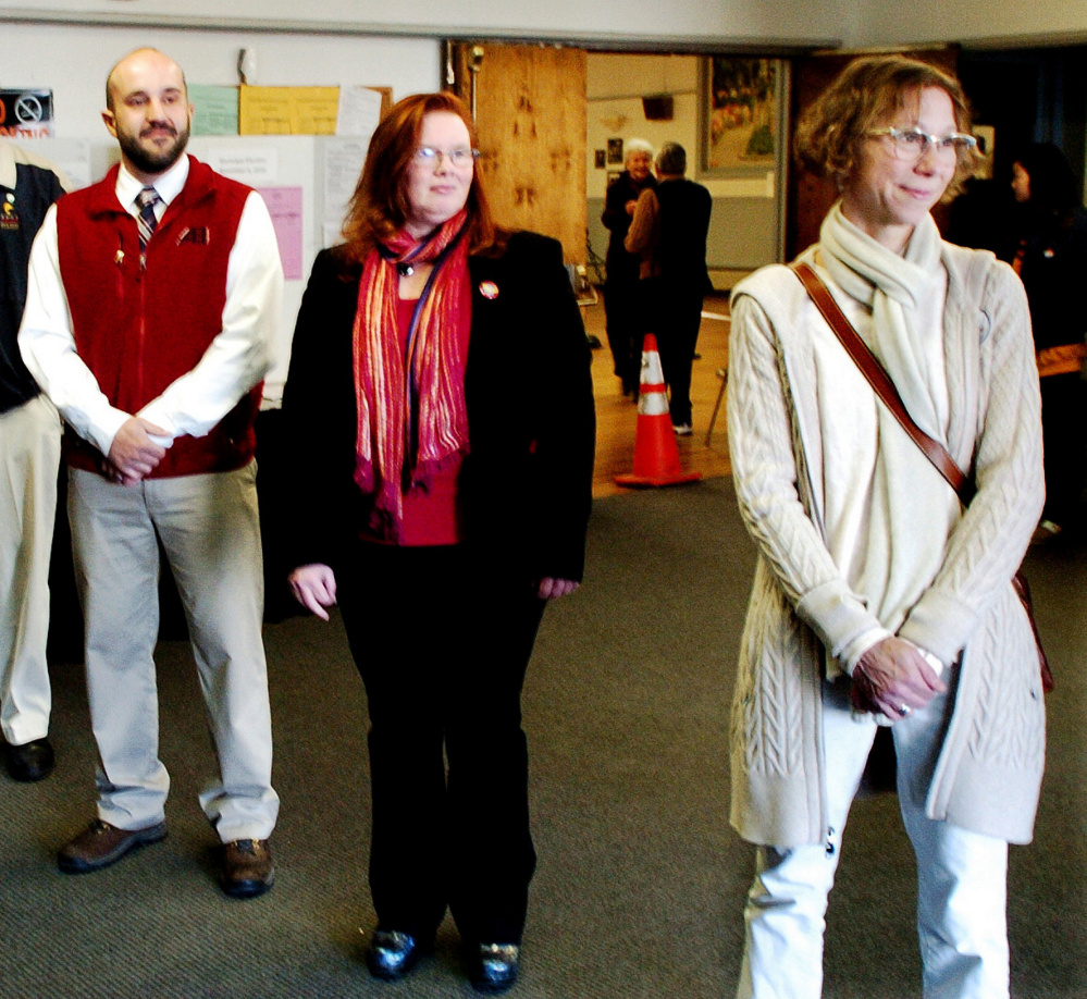 New Waterville city councilors Nick Champagne, left, and Lauren Lessing, right, greet voters Tuesday before the polls close on Election Day. Center is Colleen Madigan, a Democrat who beat Republican Mark Andre in the race for House District 110.