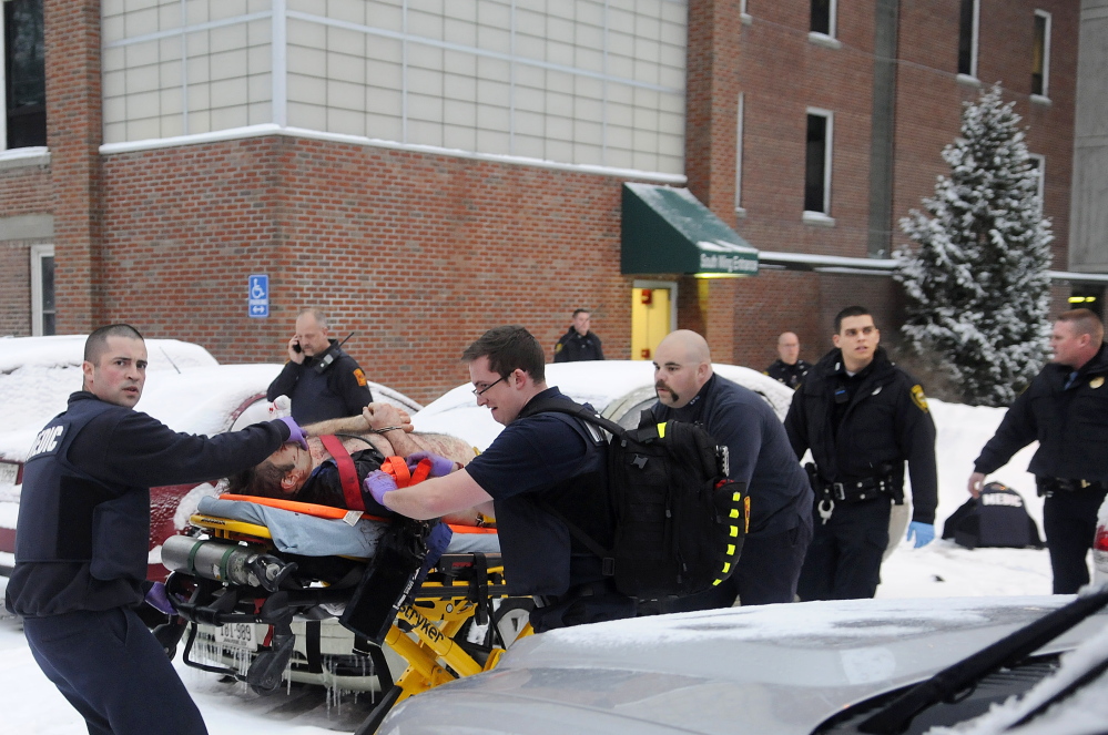 Firefighters and police escort Jason Begin, who was shot by an Augusta police officer in January 2015 during a confrontation at an office at the former MaineGeneral Medical Center in Augusta.