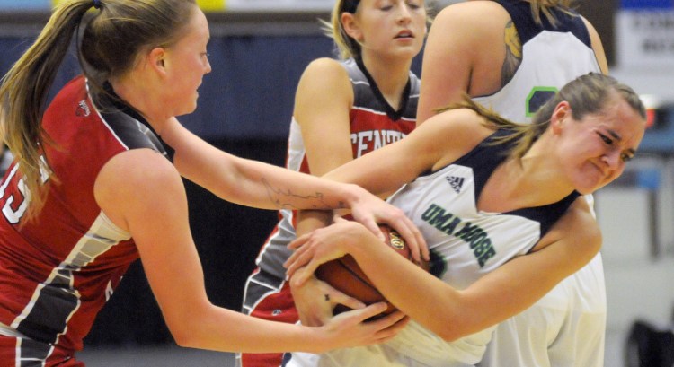 University of Maine at Augusta forward Jamie Plummer, right, wrestles with Central Maine Community College forward Taylor Estes during a game Thursday night at the Augusta Civic Center.