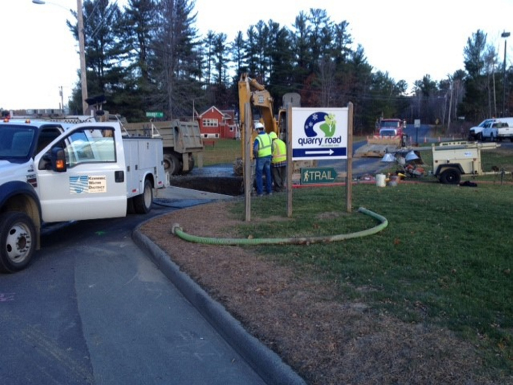 Kennebec Water District workers try to fix a broken water main Friday morning at the entrance to Quarry Road.