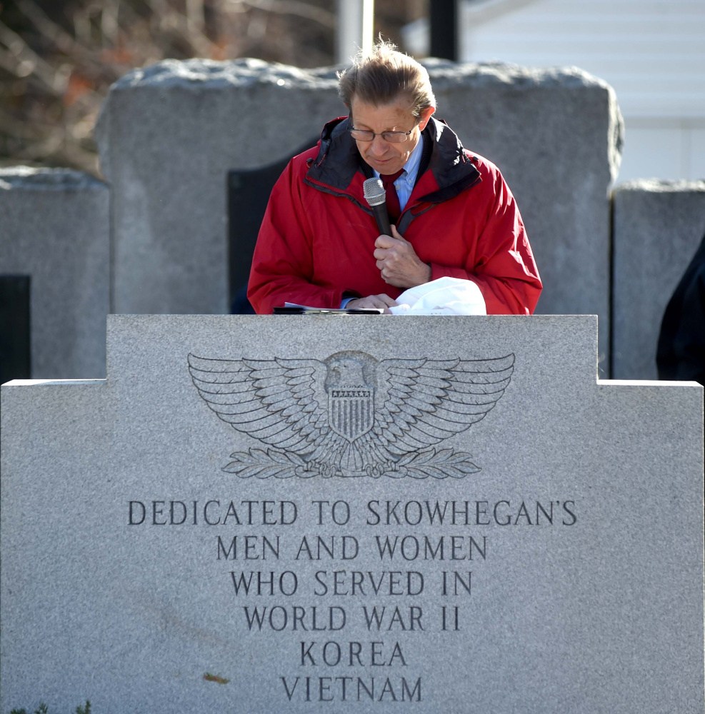 Peter Mills, president of the Maine Turnpike Authority, speaks at a lectern Friday during a re-dedication of Veterans Memorial Park in Skowhegan.