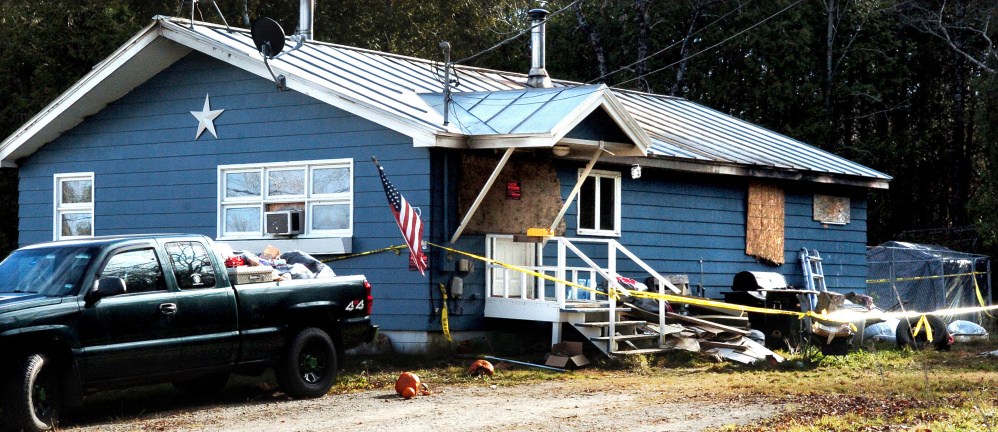 This fire damaged home on the Ford Hill Road in Hartland is boarded up and has police tape around it on Sunday.