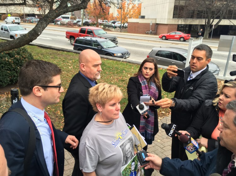 Sue Garland and William Garland, right, parents of Connor Garland, who was injured in an October 2014 hayride accident in Mechanic Falls, speak to the news media after Tuesday's plea agreement.