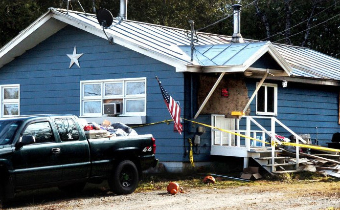 This fire-damaged home on Ford Hill Road in Hartland, shown Sunday, is boarded up and has police tape around it.