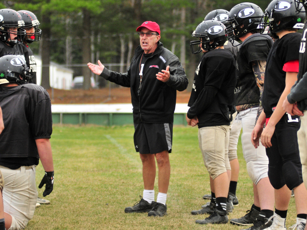 Lisbon head football coach Dick Mynahan goes over some directions during practice Tuesday in Lisbon.