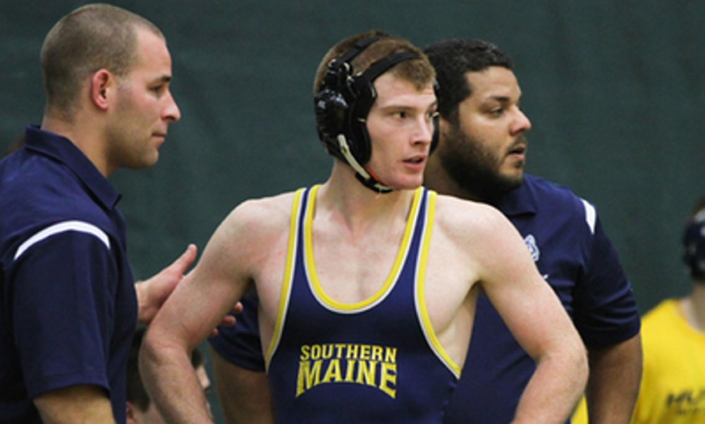 University of Southern Maine wrestler Daniel Del Gallo, a Gardiner graduate, talks with his coaches Mike Morin, left, and Julio Santiago, right, during a match recently.