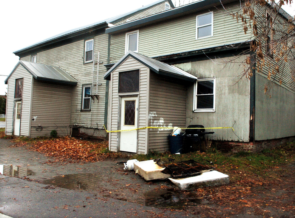 A burned mattress and other items are left discarded outside of 80 Front St. in Waterville on Sunday after fire damaged the apartment building on Saturday.