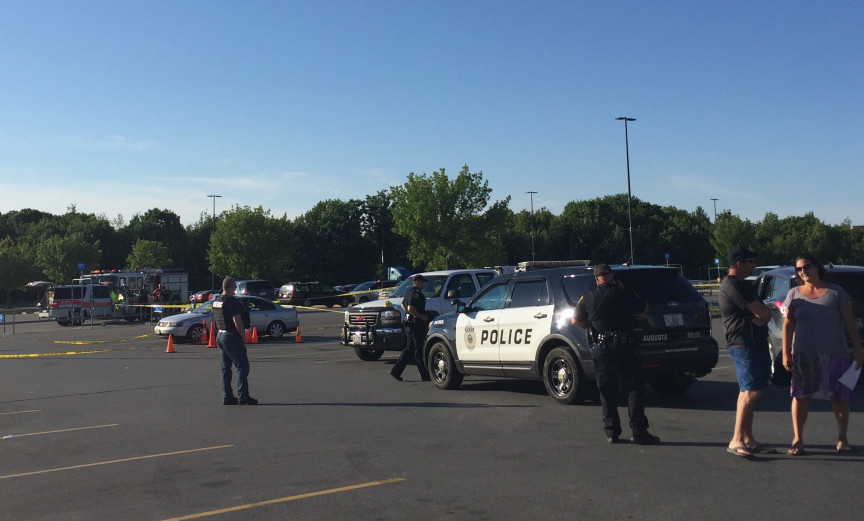 Crime scene tape surrounds a Volkswagen Jetta June 26 in a parking lot at the Wal-Mart store in Augusta as police officers look for evidence after a report of shots fired at the site.