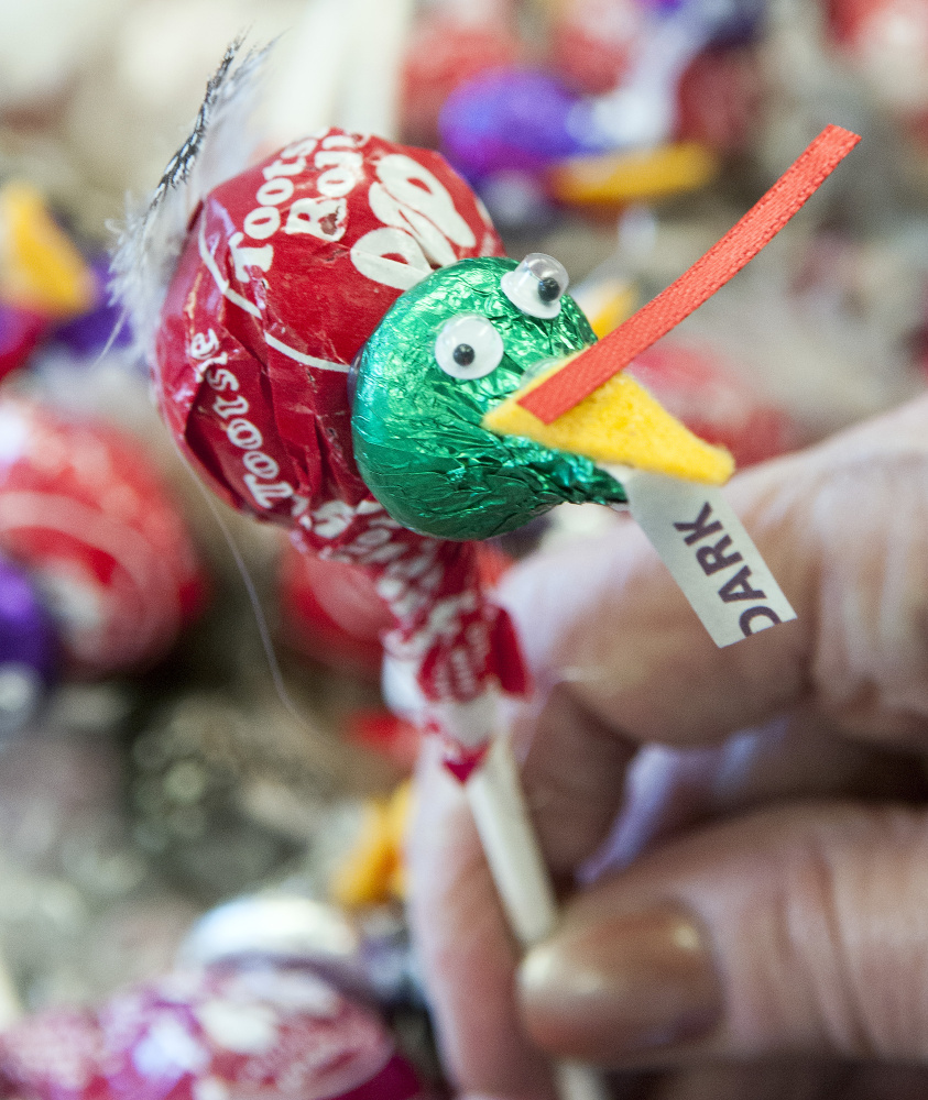 A school bus driver holds up candy turkeys that fellow driver Ted Zagwyn made to give out to students on his route Tuesday at the school bus depot in Gardiner.