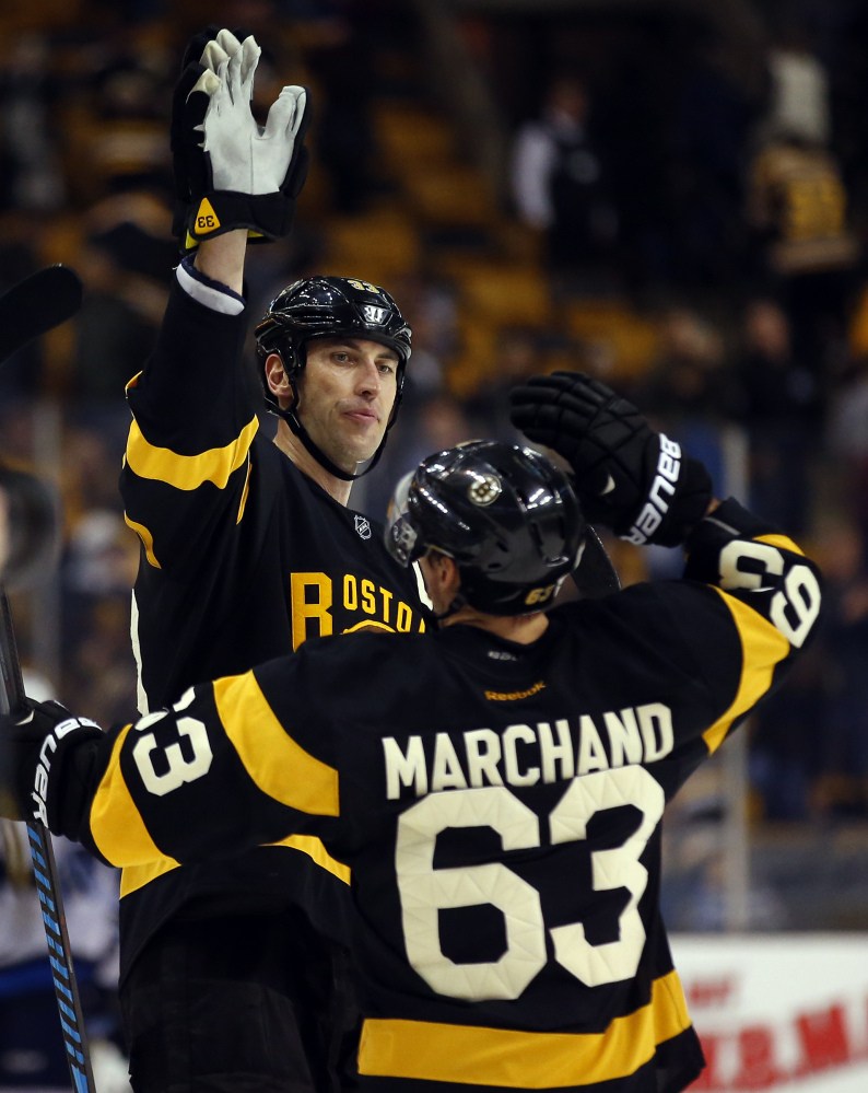 Boston Bruins defenseman Zdeno Chara congratulates Brad Marchand (63) after a 4-1 win over Winnipeg last Saturda.