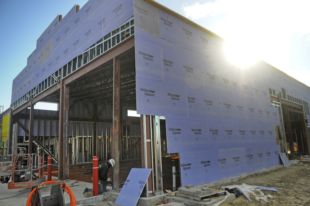 Workers build entrances for the bays at the new fire station Wednesday in Augusta.