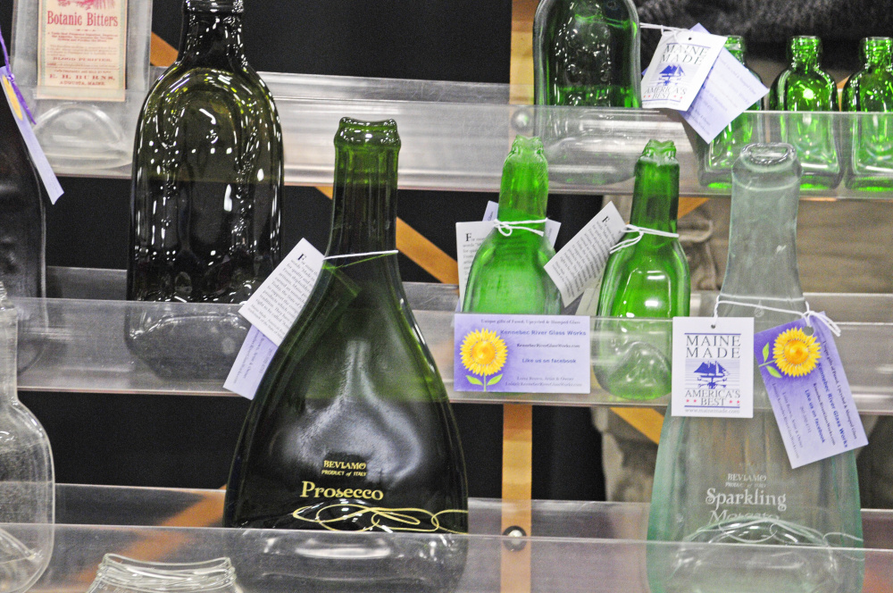 A shelf of slumped glass work by Luiza Brown, of Kennebec River Glassworks, is on display during a craft show Saturday at the Augusta Civic Center.