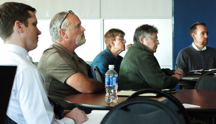 Municipal, hospital and law enforcement officials listen to speakers during a cybersecurity talk at Thomas College on Monday.