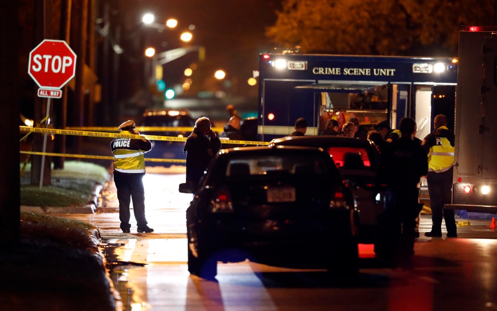 Police investigate at the scene of a shooting on Wednesday in Urbandale, Iowa. 