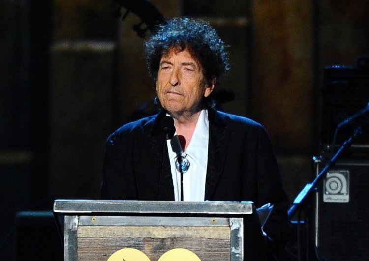 Bob Dylan, shown here accepting the 2015 MusiCares Person of the Year award in Los Angeles, won't travel to Stockholm to receive the Nobel Prize for Literature on Dec. 10, but he is still required to deliver a Nobel lecture within six months of that date. <em>Vince Bucci/Invision/AP</em>