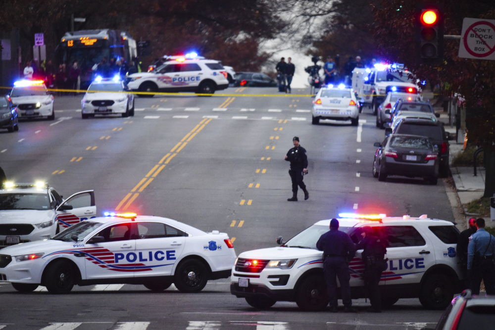 Police secure the scene near Comet Ping Pong in Washington, Sunday, Dec. 4, 2016. A man who said he was investigating a conspiracy theory about Hillary Clinton running a child sex ring out of the pizza place fired an assault rifle inside the restaurant on Sunday injuring no one, police and news reports said.