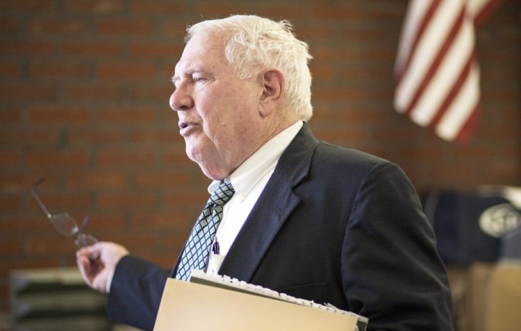 William Beardsley talks to a reporter at Casco Bay High School in Portland after announcing his resignation Wednesday as deputy commissioner of education.