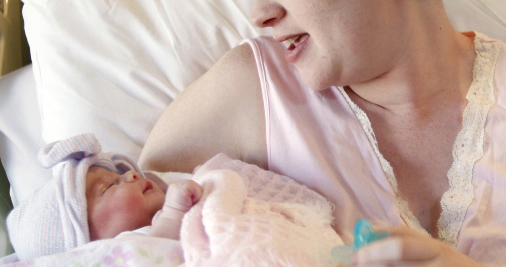 A mother holds her newborn baby in Corpus Christi, Texas.