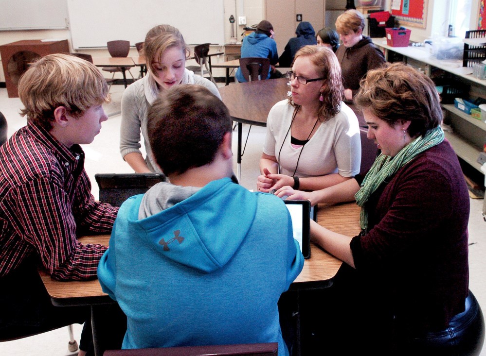 Cornville Regional Charter School teacher Ashlee Savage, second from right, speaks with students at the school on Tuesday, the same day that the school found out it has permission to expand from the existing kindergarten to eighth grade to pre-kindergarten through grade 12 next year. From left are Tyler Perry, Amber Savage, Ashlee Savage and Ayden Bosworth and Lydia Dore in foreground.