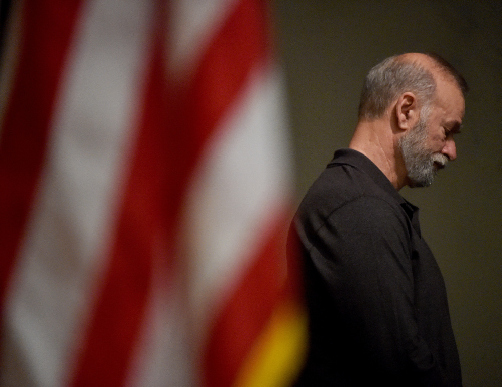 Dave Anderson lowers his head Wednesday evening during a moment of silence that was part of a Pearl Harbor remembrance ceremony at the Waterville Elks lodge.