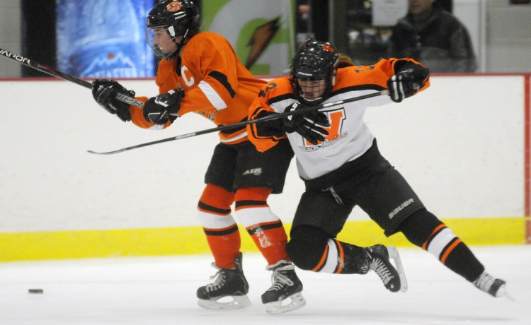 Winslow/Gardiner's Sarah Stevens, right, flies after colliding with Brunswick's Anna Webster Wednesday night in Kents Hill. The Black Tigers won in overtime.