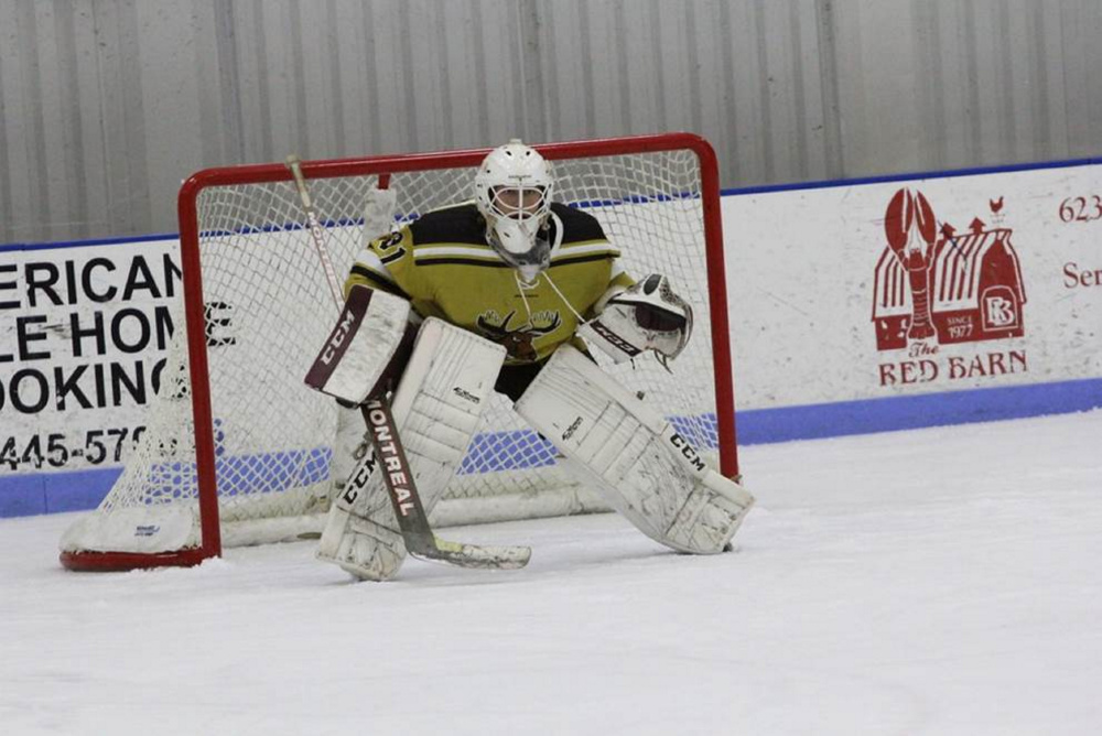 Derek Fournier, of Bangor, waits to make a play for the Maine Moose 18U hockey team. Fournier and Esa Maki rotate in goal for the Moose.