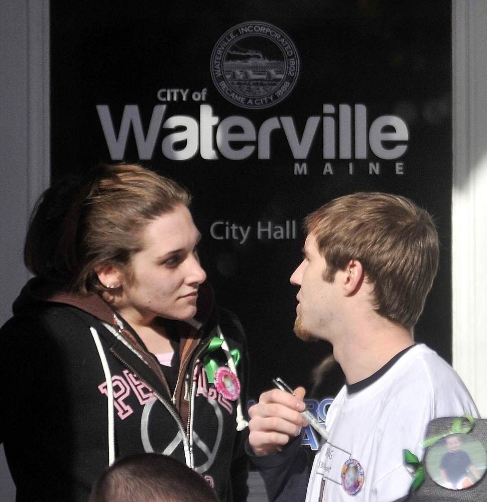 Trista Reynolds, left, and Justin DePietro, right, mother and father of missing child Ayla Reynolds, speak on the steps of City Hall during a Waterville vigil in January 2012 for their missing toddler.