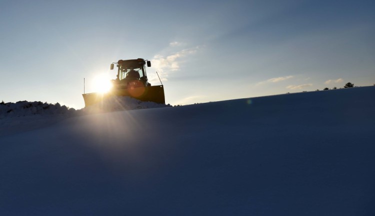 Crews at the Quarry Road Recreational Area in Waterville get ahead of the weather by clearing a parking area at the hut  earlier this week before arctic temperatures settled in to the area.