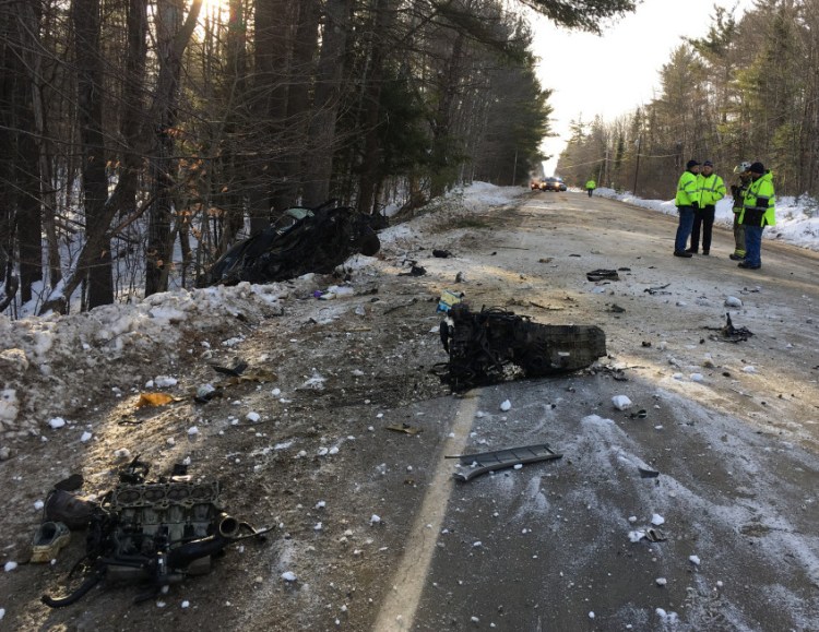 Police and emergency responders work Tuesday morning at the scene of a fatal car crash on Route 145 in Freeman Township.