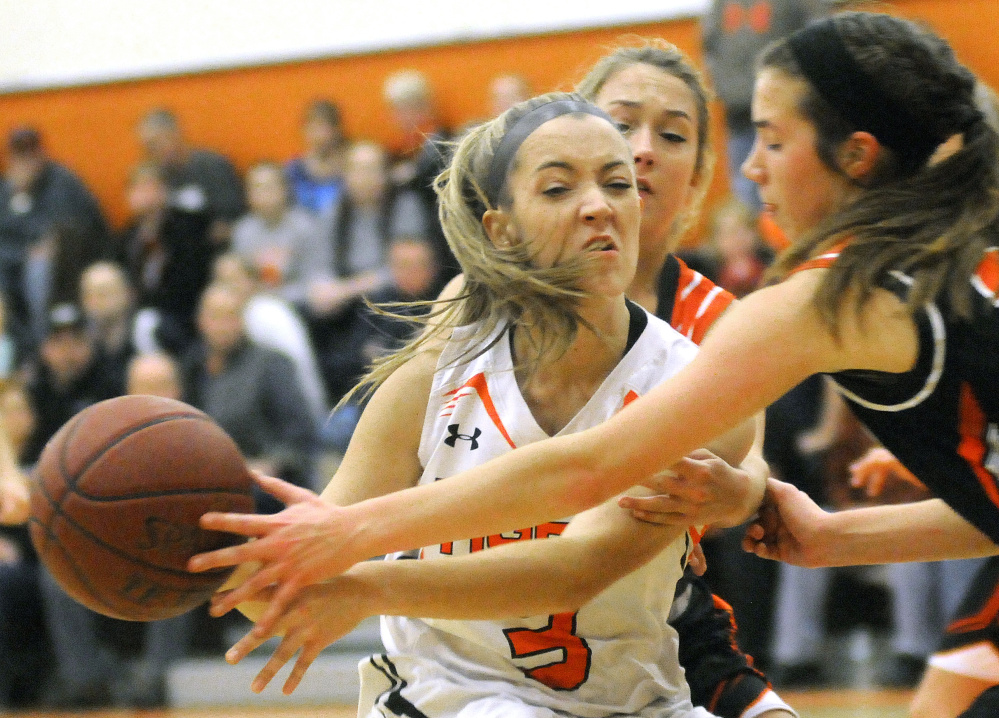 Gardiner's Mikayla Bourassa (3) is sandwiched by Brewer's Courtney Pearson, right, and Haley Robertson during a Class A North game Wednesday in Gardiner.