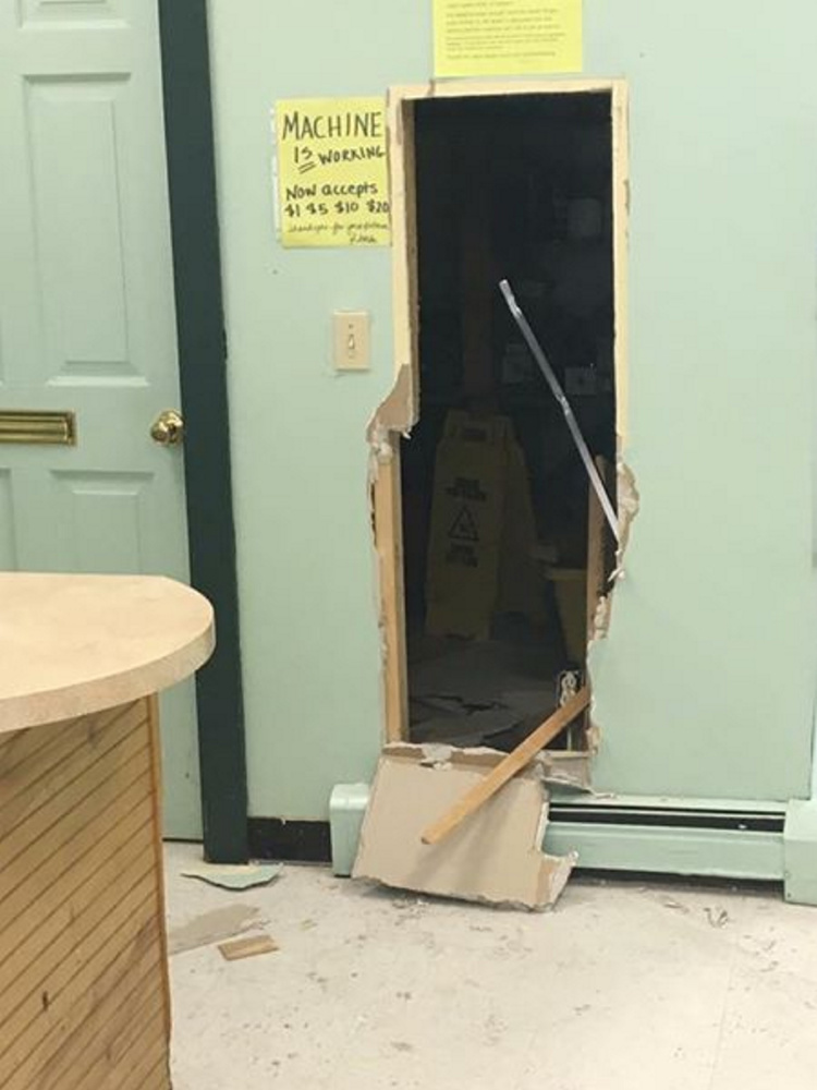 A photo taken by Rhonda Emerson, who owns Elm House Laundromat on Main Street in Madison, shows where a wall was knocked out Saturday and a coin change machine and safe were stolen.