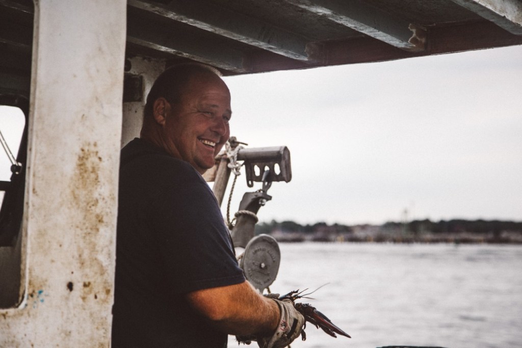 Jim Buxton, shown on his lobster boat in Casco Bay, appears in a new online documentary series “Wharfside: Stories From Portland Harbor’s Working Waterfront.” Buxton, 49, is a lobsterman and shellfish diver who has been tying up at Merrill's Wharf in Portland for more than 20 years, and he hopes the city continues to support a working waterfront. Photo by Jenny Rebecca Nelson/ Courtesy of Galen Koch