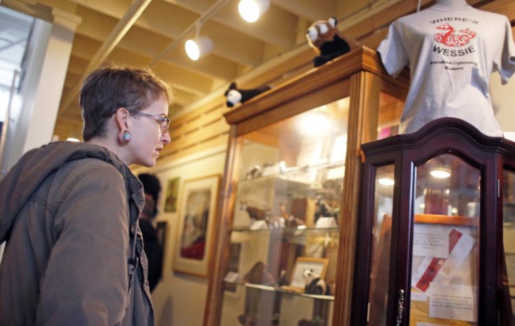 Ashlynn Sylvain of Philadelphia looks over the Wessie the snake exhibit at the International Cryptozoology Museum.