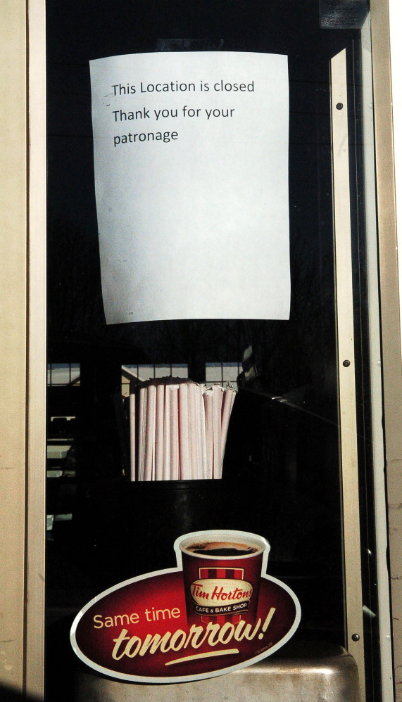 Signs posted at the drive-up window at Tim Hortons restaurant in Waterville on Monday state the business has been closed.