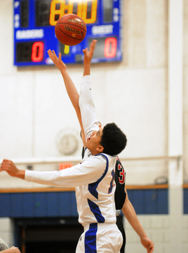 Oak Hill's Marcus Bailey, front, and Hall-Dale's Alec Roberts go up for the opening tipoff during a game Tuesday in Wales.