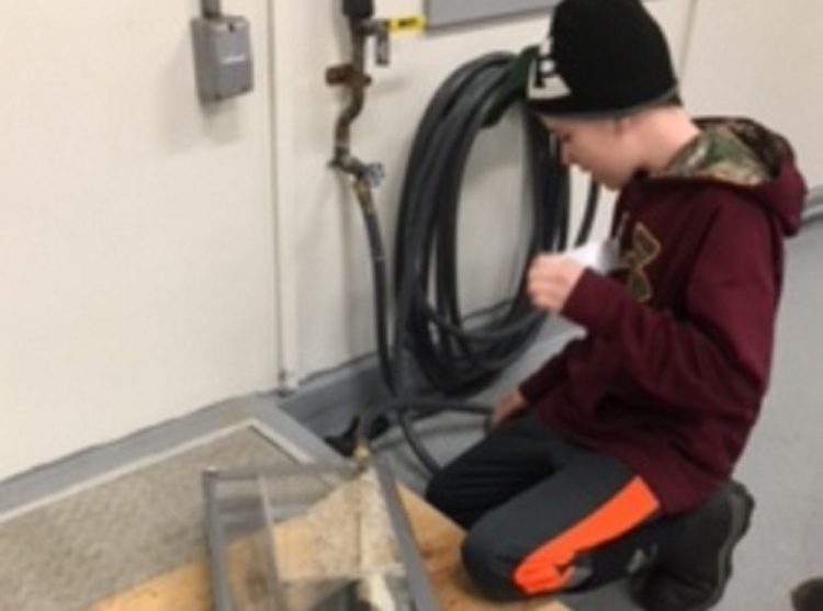 Forest Hills Consolidated School eighth grader Joey Poulin created a water filter during the Jackman Water District's open house. Parker Desjardins, also an eighth grader, not pictured, worked together with Poulin on their project.