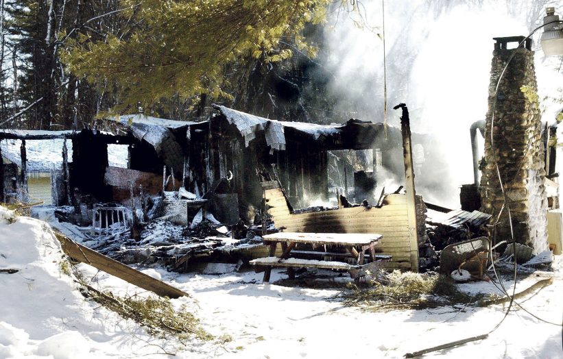 Smoke rises on Sunday from the remains of a home on Washington Boulevard in China, where the owner, Randall Luck, was found dead Sunday morning outside the home.