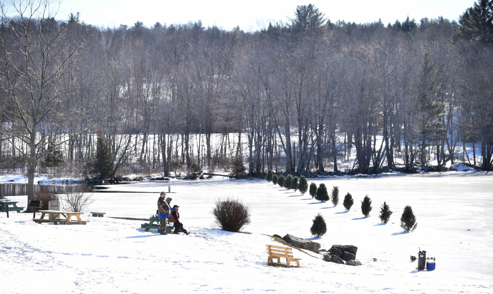 A row of trees marks the end of the safe ice on Messalonskee Lake in Oakland on Saturday.