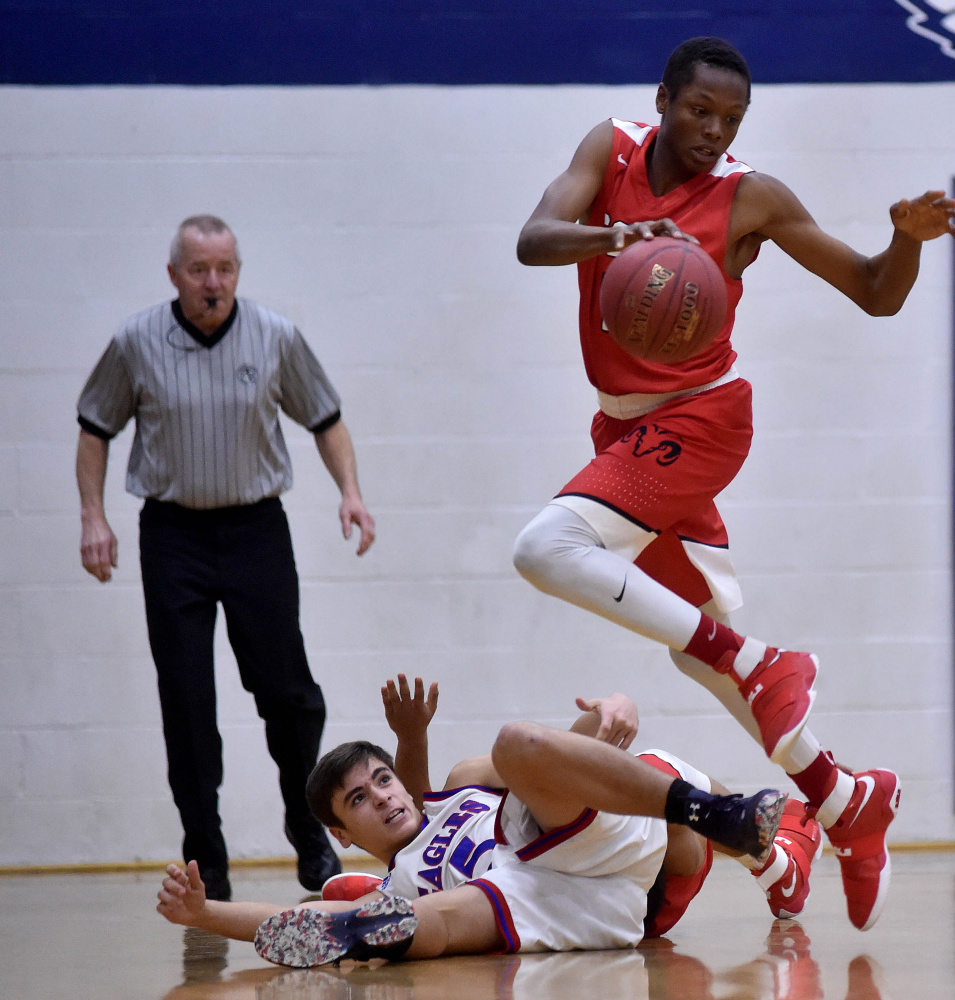 Cony's Amahde Carter, right, emerges from a pile of players with the loose ball against Messalonskee on Saturday in Oakland.