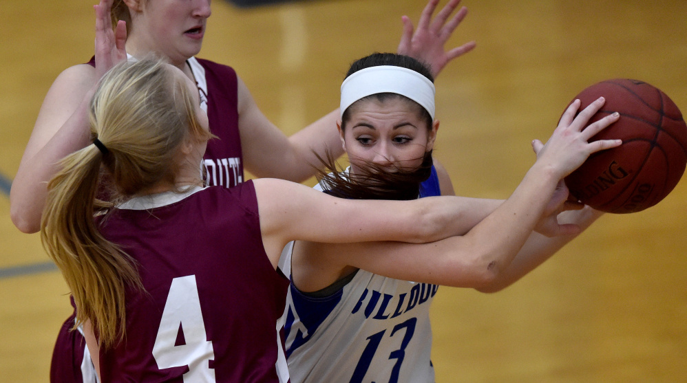 Madison freshman Emily Edgerly, right, looks to pass the ball as Monmouth sophomore guard Julia Johnson defends during a Mountain Valley Conference game Tuesday night.