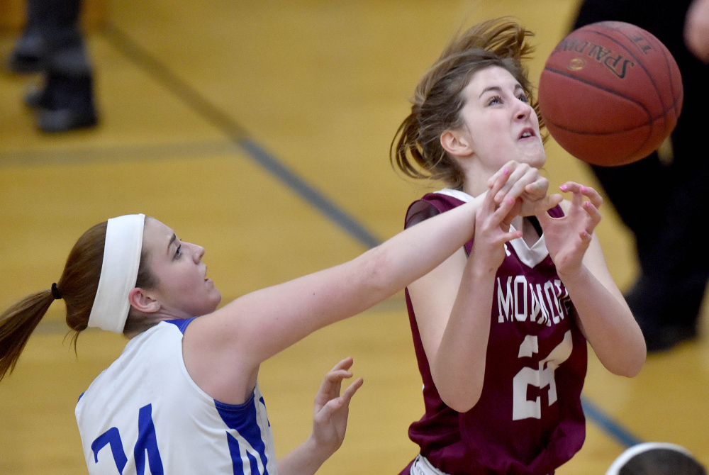Madison junior Marah Hall, left, fouls Monmouth's Kaeti Butterfield during a Mountain Valley Conference game Tuesday night.