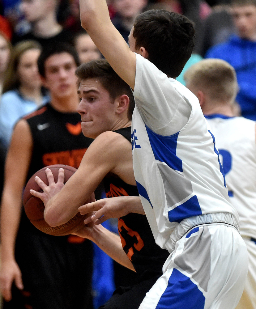 Skowhegan senior captain Brendan Curran, left, drives to the basket during a Kennebec Valley Athletic Conference Class A game against Lawrence on Friday night in Fairfield.