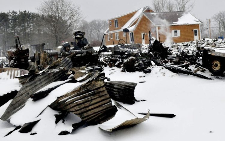 Smoke continues to rise Tuesday from the burned remains of a barn on West Ridge Road in Cornville, which was destroyed by fire the previous evening. A 14-year-old girl living at the residence has been charged with arson in connection with the blaze.