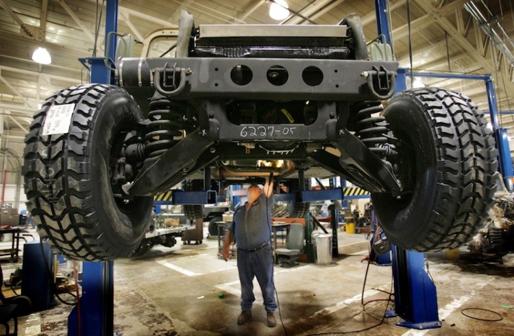 A mechanic inspects the underside of a refurbished Humvee at the Maine Military Authority in Limestone in 2005. Over the years, Maine Military Authority refurbished more than 16,000 vehicles, generated $600 million in revenue and, at its peak, employed roughly 550 workers.