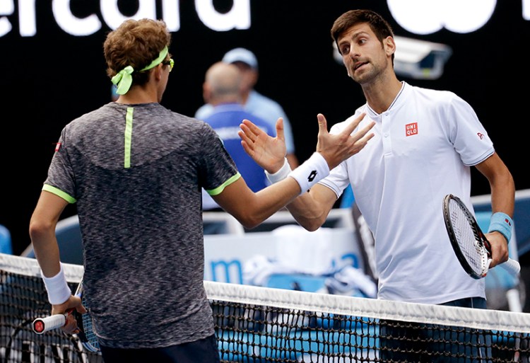 Serbia's Novak Djokovic, right, congratulates Uzbekistan's Denis Istomin after winning their second round match.